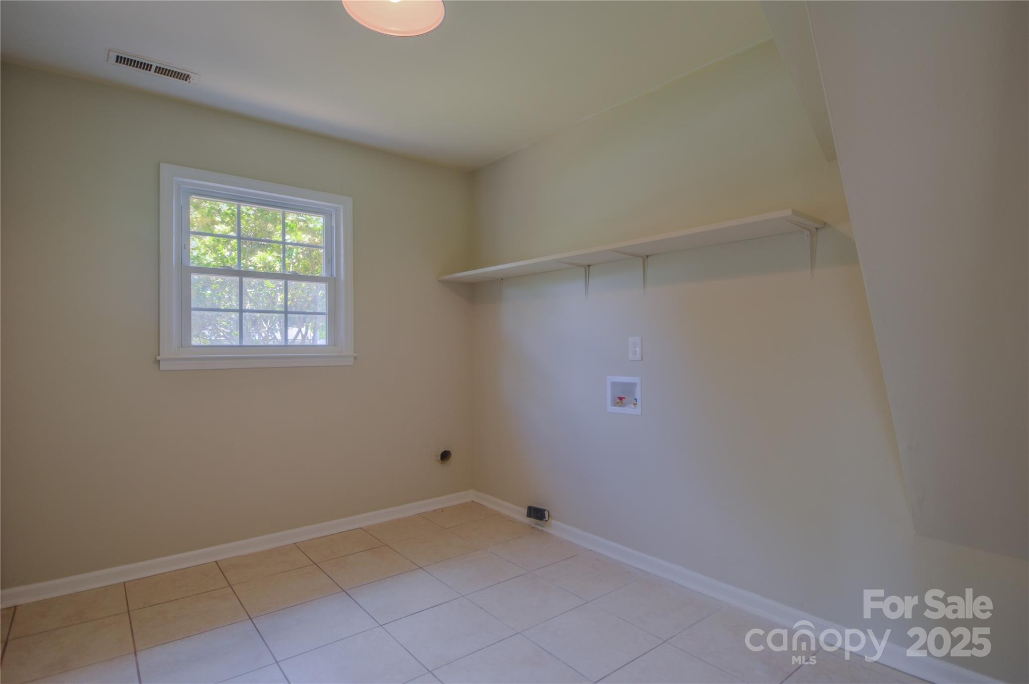 6921 Idlewild Road Charlotte, NC 28212 - Photo 22 of 29 a view of an empty room with a window