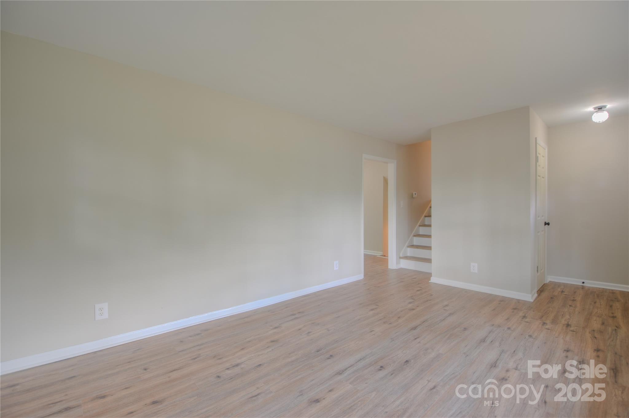 6921 Idlewild Road Charlotte, NC 28212 - Photo 4 of 29 a view of an empty room and wooden floor