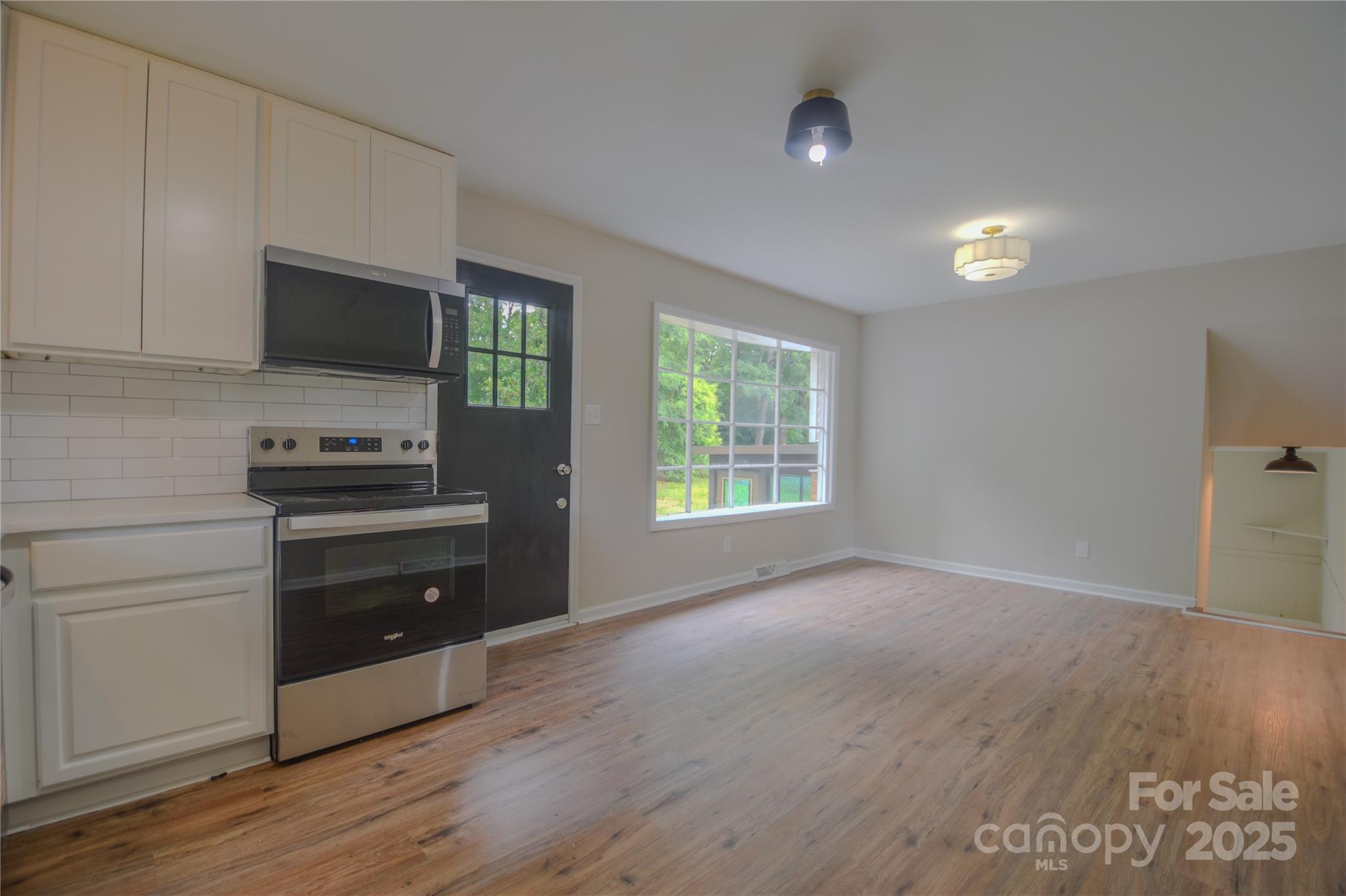 6921 Idlewild Road Charlotte, NC 28212 - Photo 7 of 29 a kitchen with a refrigerator and a stove top oven