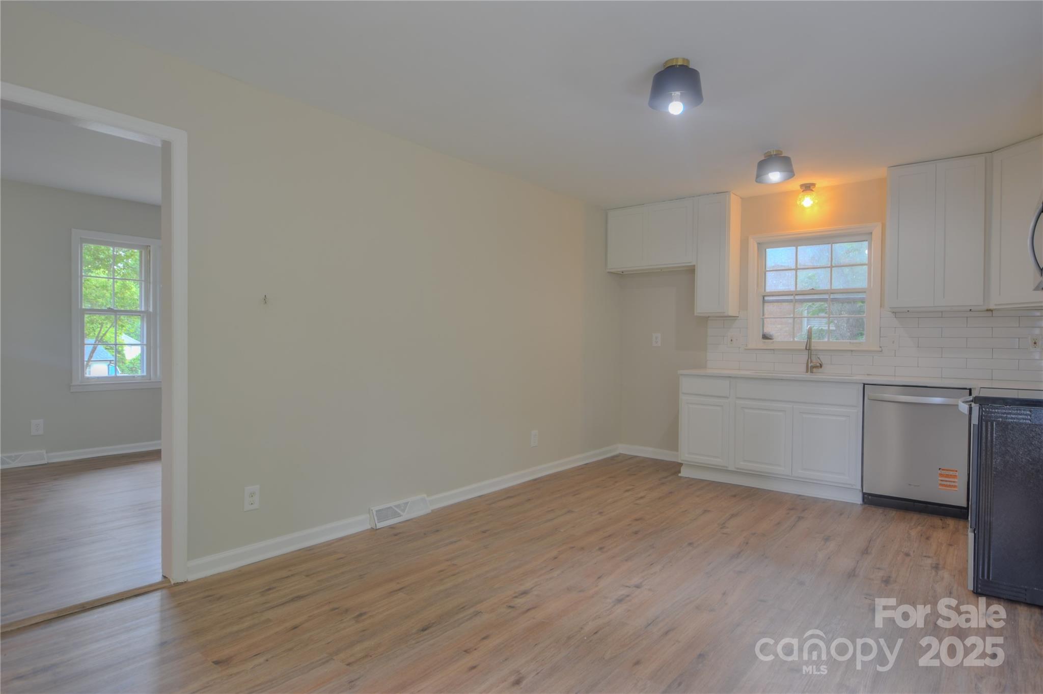 6921 Idlewild Road Charlotte, NC 28212 - Photo 9 of 29 a view of a kitchen with a sink cabinets and wooden floor