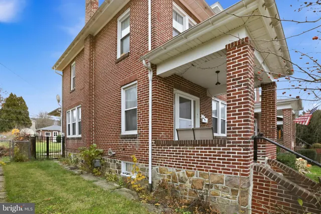 a view of a brick house with a large window