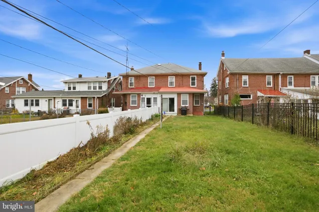 a front view of a residential apartment building with a yard