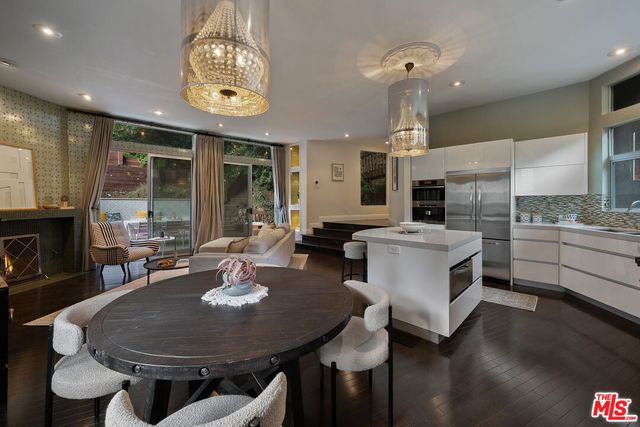 a kitchen with a table chairs stove and cabinets
