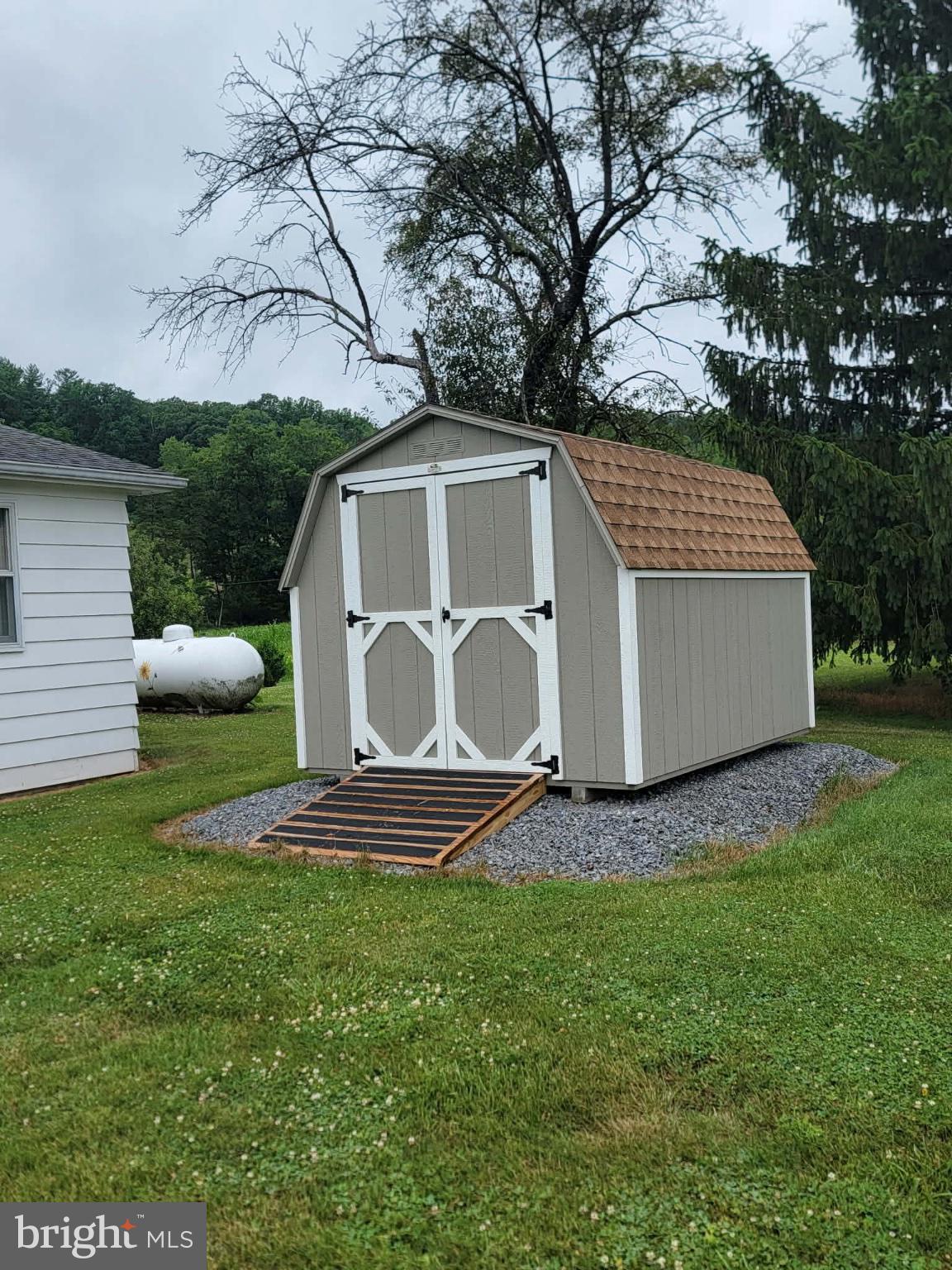 7296 Thompson Road Needmore, PA 17238 - Photo 39 of 40 Charming shed nestled in green landscape.