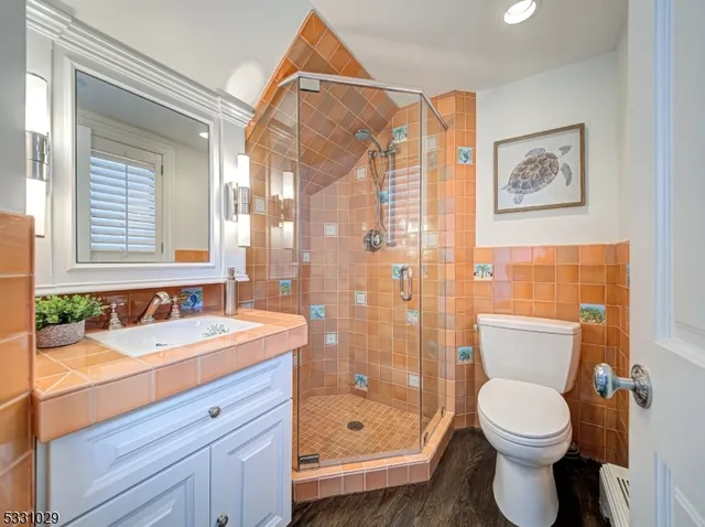 a bathroom with a sink toilet and shower