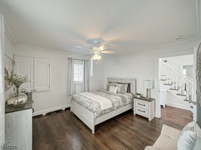 a bedroom with a bed and a potted plant