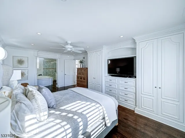 a spacious bathroom with a double vanity sink a mirror a bathtub and shower