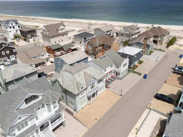 an aerial view of residential house with parking