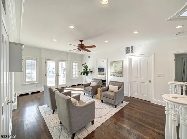a living room with fireplace furniture and a wooden floor