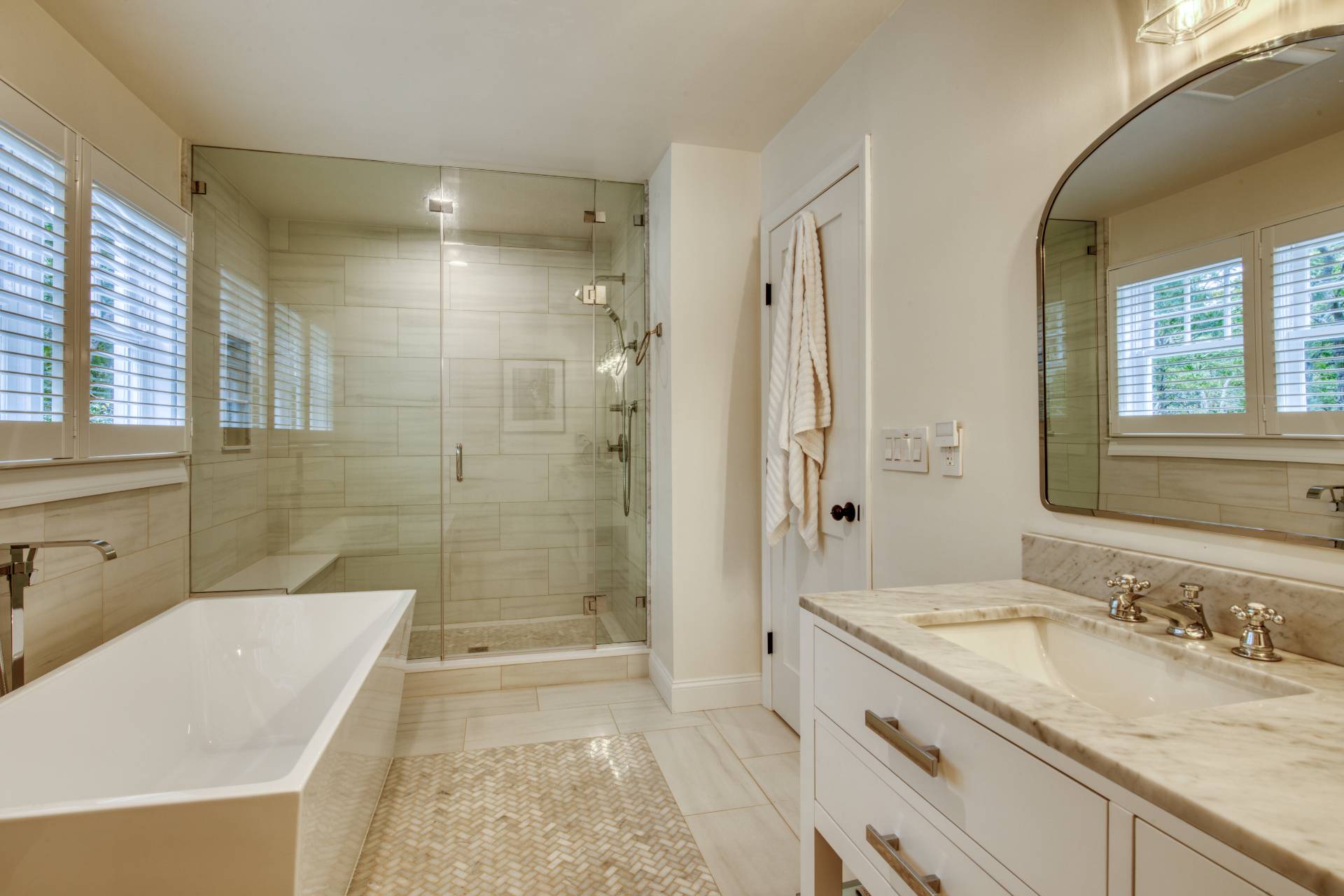 8 Grape Arbor Lane East Hampton, NY 11937 - Photo 7 of 15 a bathroom with a granite countertop sink a mirror a bathtub and shower