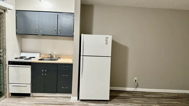 a kitchen with a sink and a refrigerator