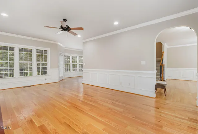 a view of an empty room with a fireplace and a window