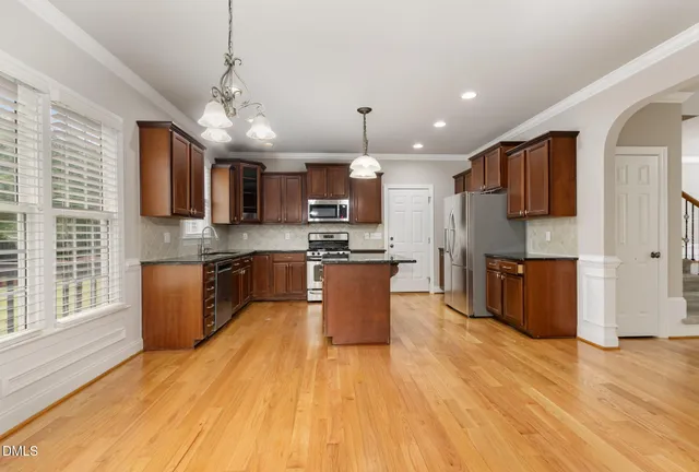 a view of entryway and hall with wooden floor