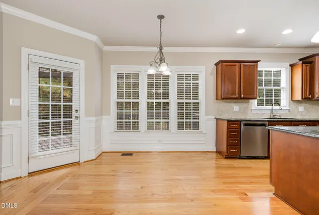 an empty room with windows and ceiling fan