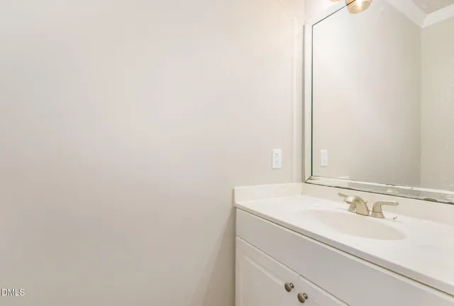 an empty room with windows and ceiling fan