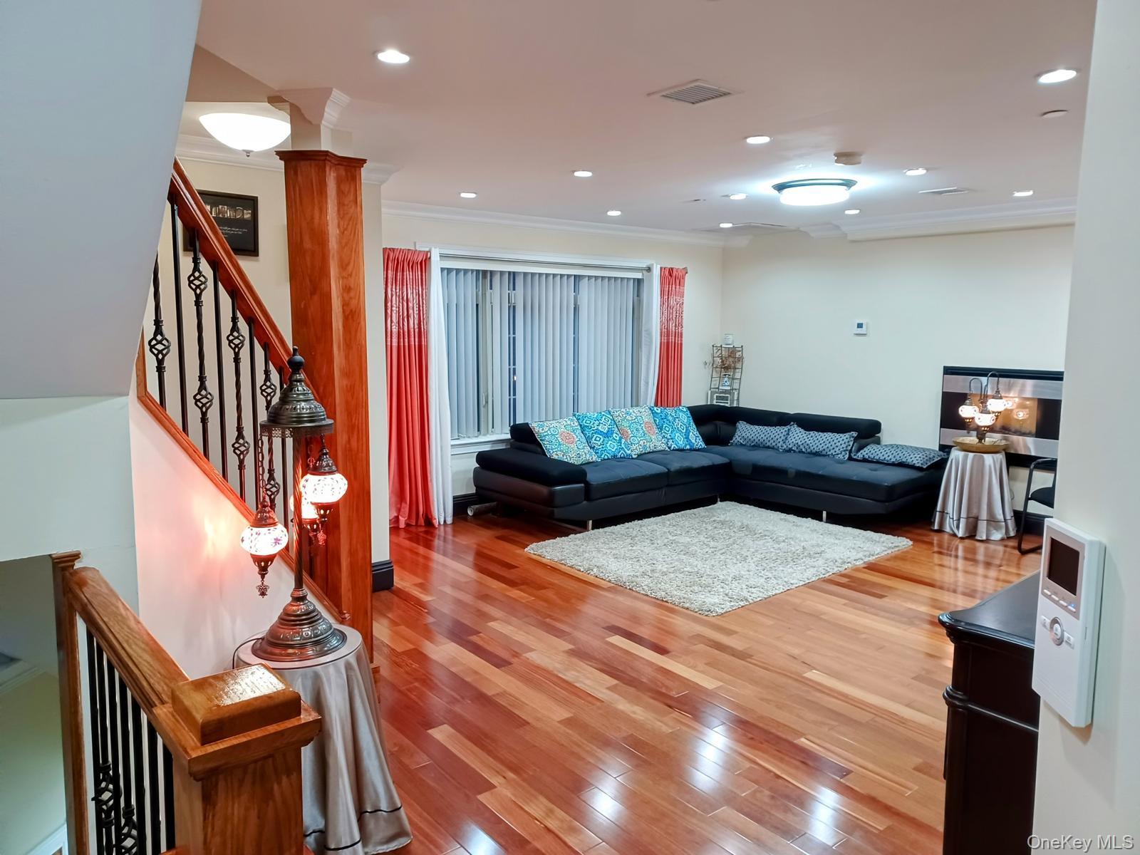 127-22 Kew Gardens Road Queens, NY 11415 - Photo 13 of 21 a living room with furniture and a flat screen tv