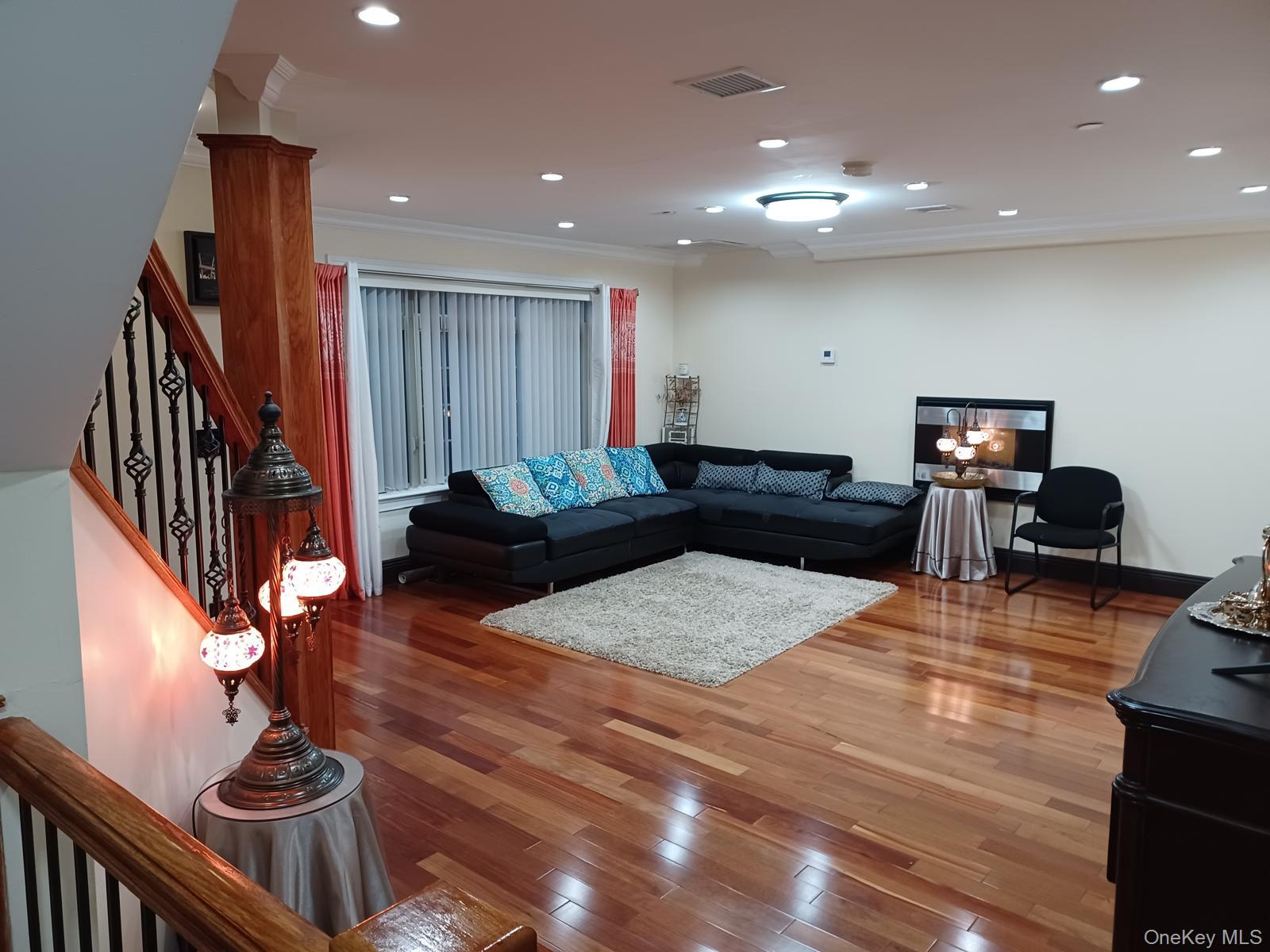 127-22 Kew Gardens Road Queens, NY 11415 - Photo 15 of 21 a living room with furniture and wooden floor