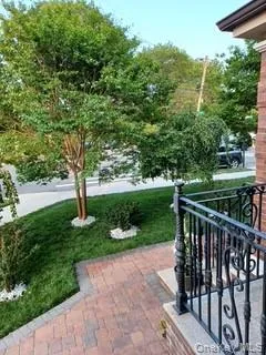 a view of a deck with a big yard and potted plants