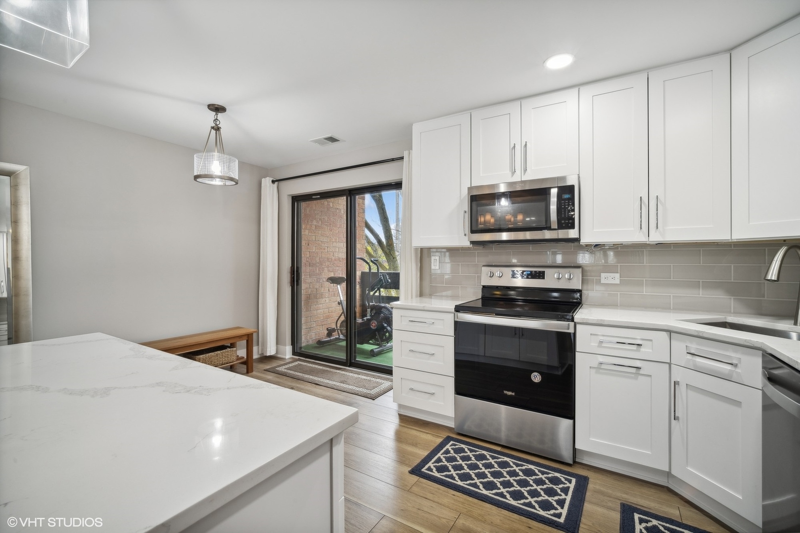 1088 Shermer Road, Unit 204 Northbrook, IL 60062 - Photo 11 of 28 a kitchen with stainless steel appliances a stove a microwave and cabinets