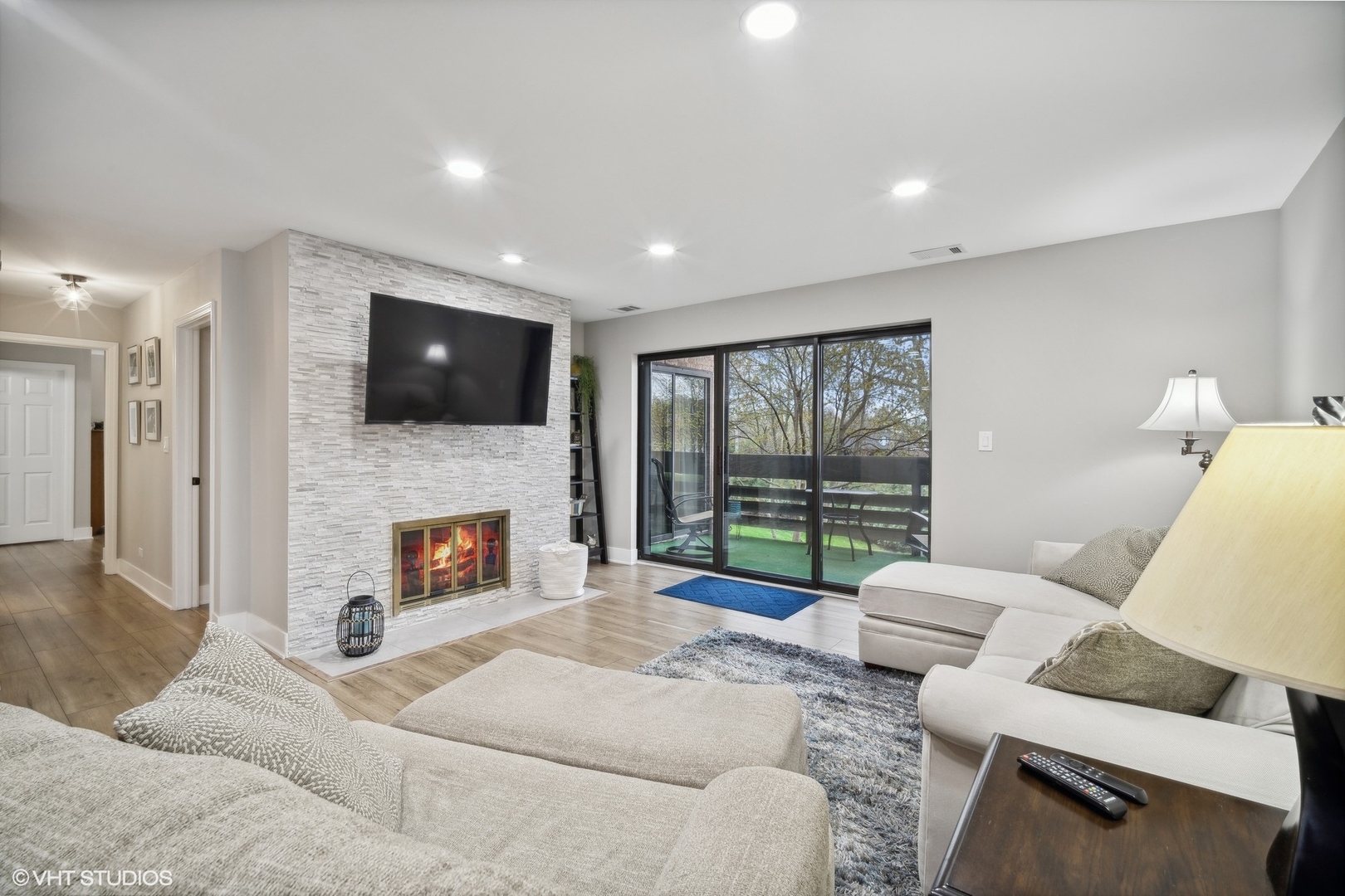 1088 Shermer Road, Unit 204 Northbrook, IL 60062 - Photo 13 of 28 a living room with furniture a fireplace and a flat screen tv