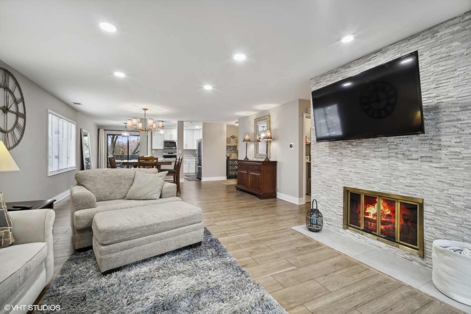 1088 Shermer Road, Unit 204 Northbrook, IL 60062 - Photo 16 of 28 a living room with furniture a flat screen tv and a fireplace