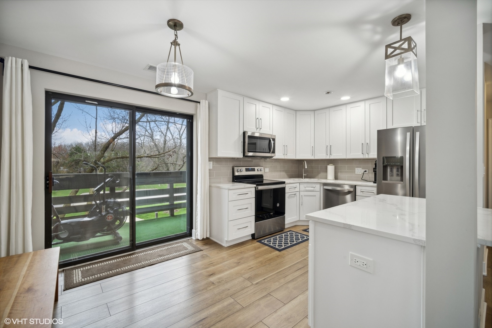 1088 Shermer Road, Unit 204 Northbrook, IL 60062 - Photo 7 of 28 a kitchen with white cabinets and stainless steel appliances