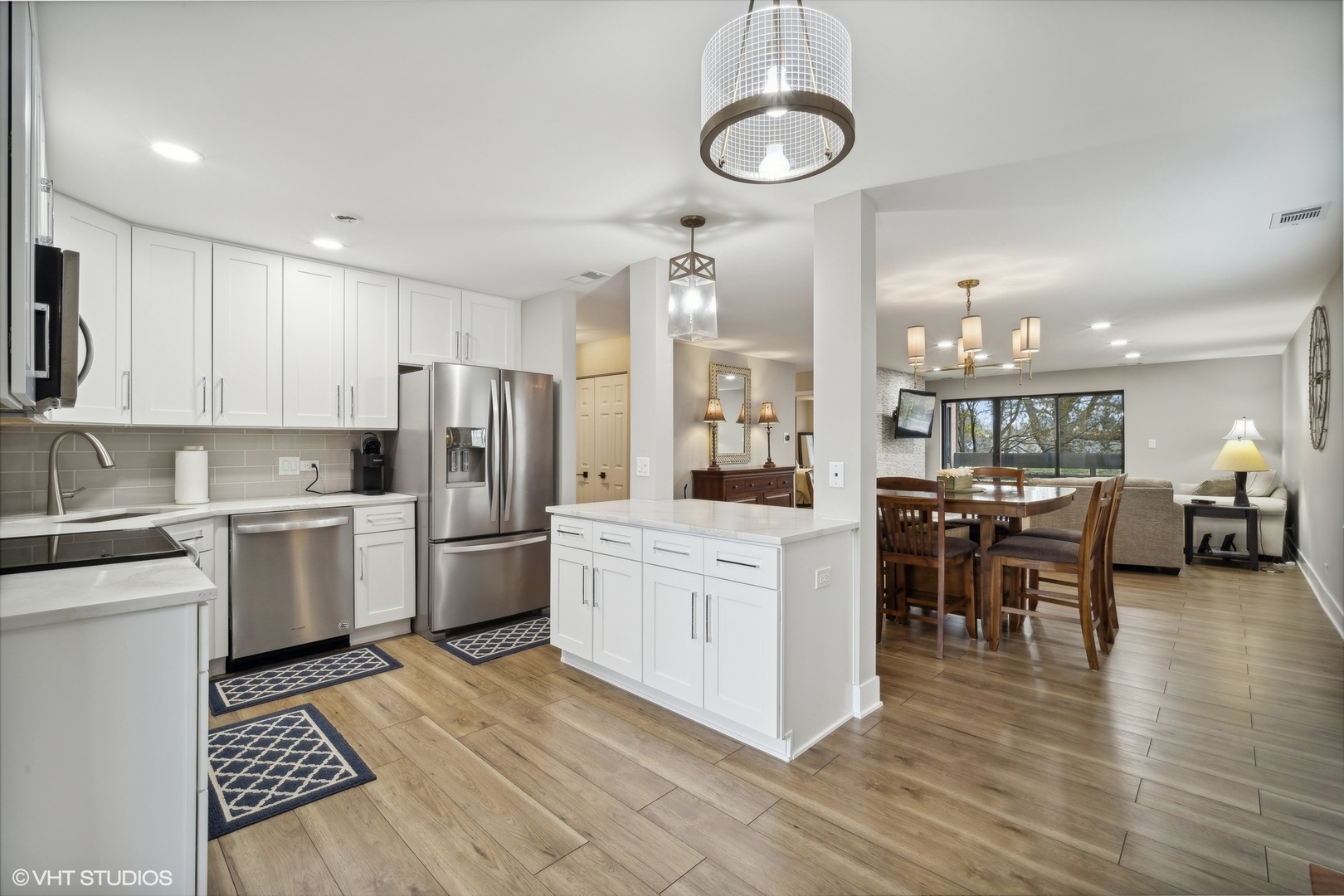 1088 Shermer Road, Unit 204 Northbrook, IL 60062 - Photo 8 of 28 a kitchen with a refrigerator a stove top oven a sink dishwasher and white cabinets with wooden floor
