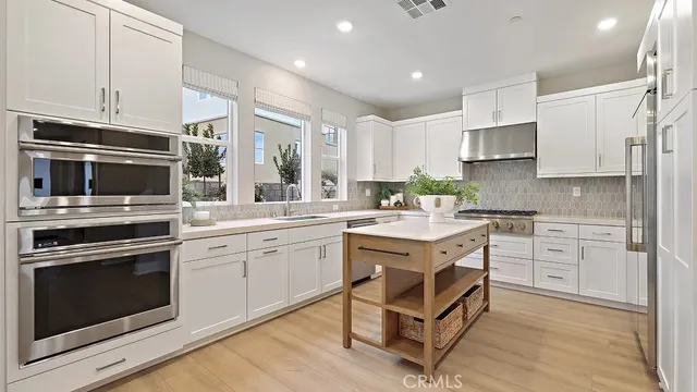 a kitchen with a sink stove and microwave