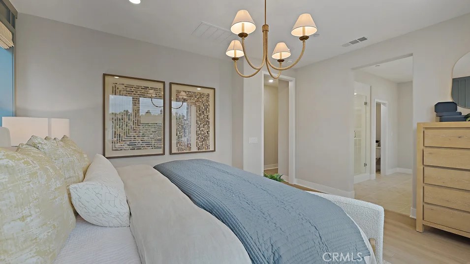1711 Lychee Street Fullerton, CA 92833 - Photo 12 of 29 a spacious bedroom with a bed and a chandelier