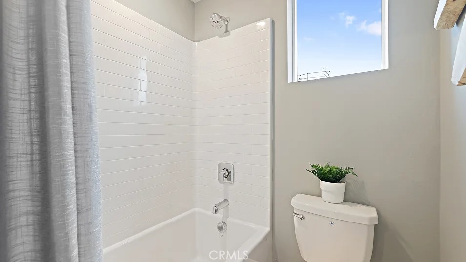 1711 Lychee Street Fullerton, CA 92833 - Photo 19 of 29 a bathroom with a toilet a sink a bath tub and mirror