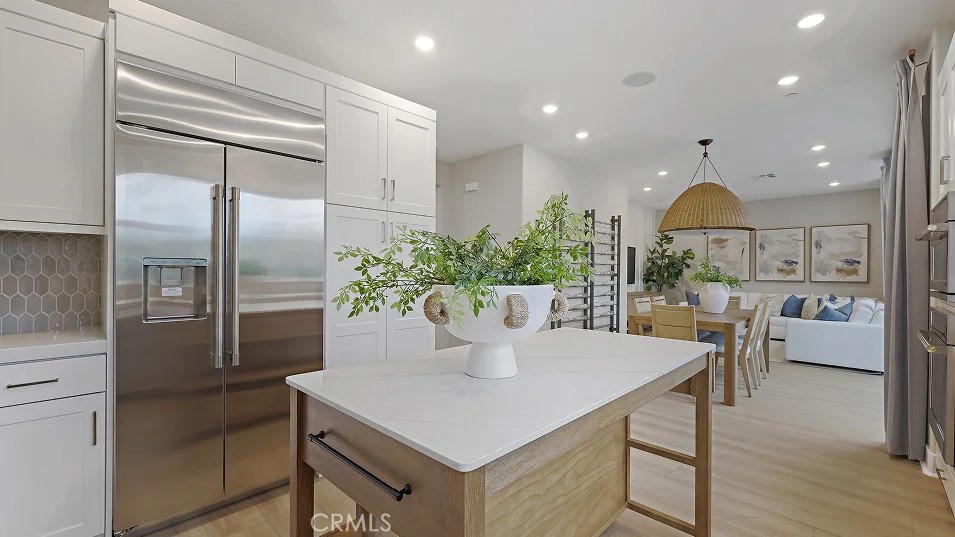 1711 Lychee Street Fullerton, CA 92833 - Photo 2 of 29 a kitchen with stainless steel appliances a dining table chairs and wooden floor