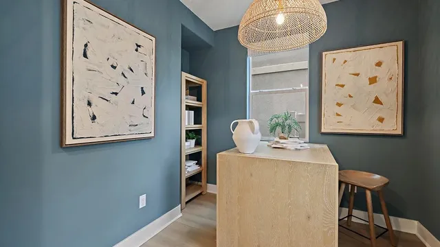 a bedroom with furniture and a large window