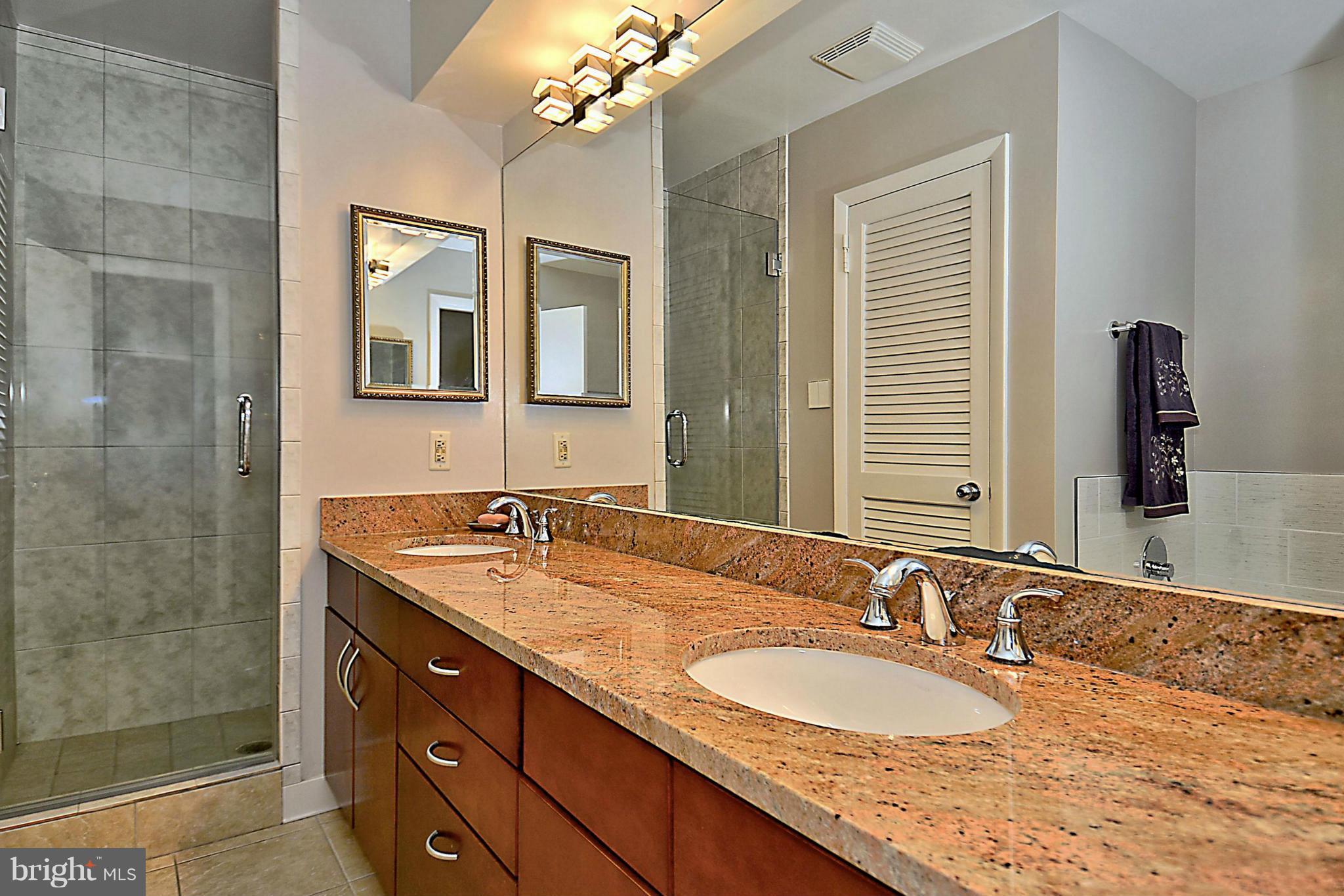 10020 Ormond Road Potomac, MD 20854 - Photo 23 of 30 Hall Bathroom with Double Vanities Tub & Shower