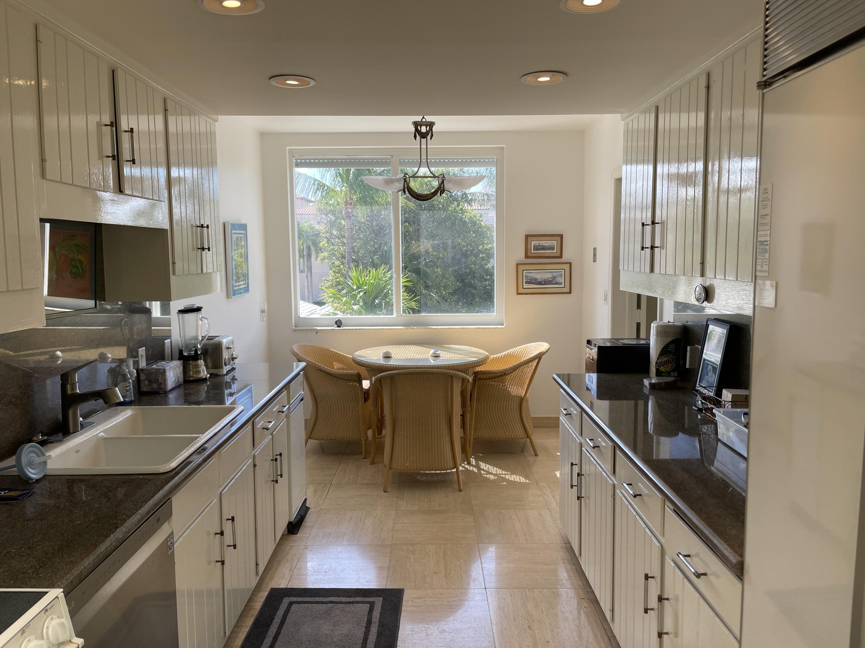 145 Peruvian Avenue, Unit 301 Palm Beach, FL 33480 - Photo 12 of 16 a kitchen with sink stove and cabinets