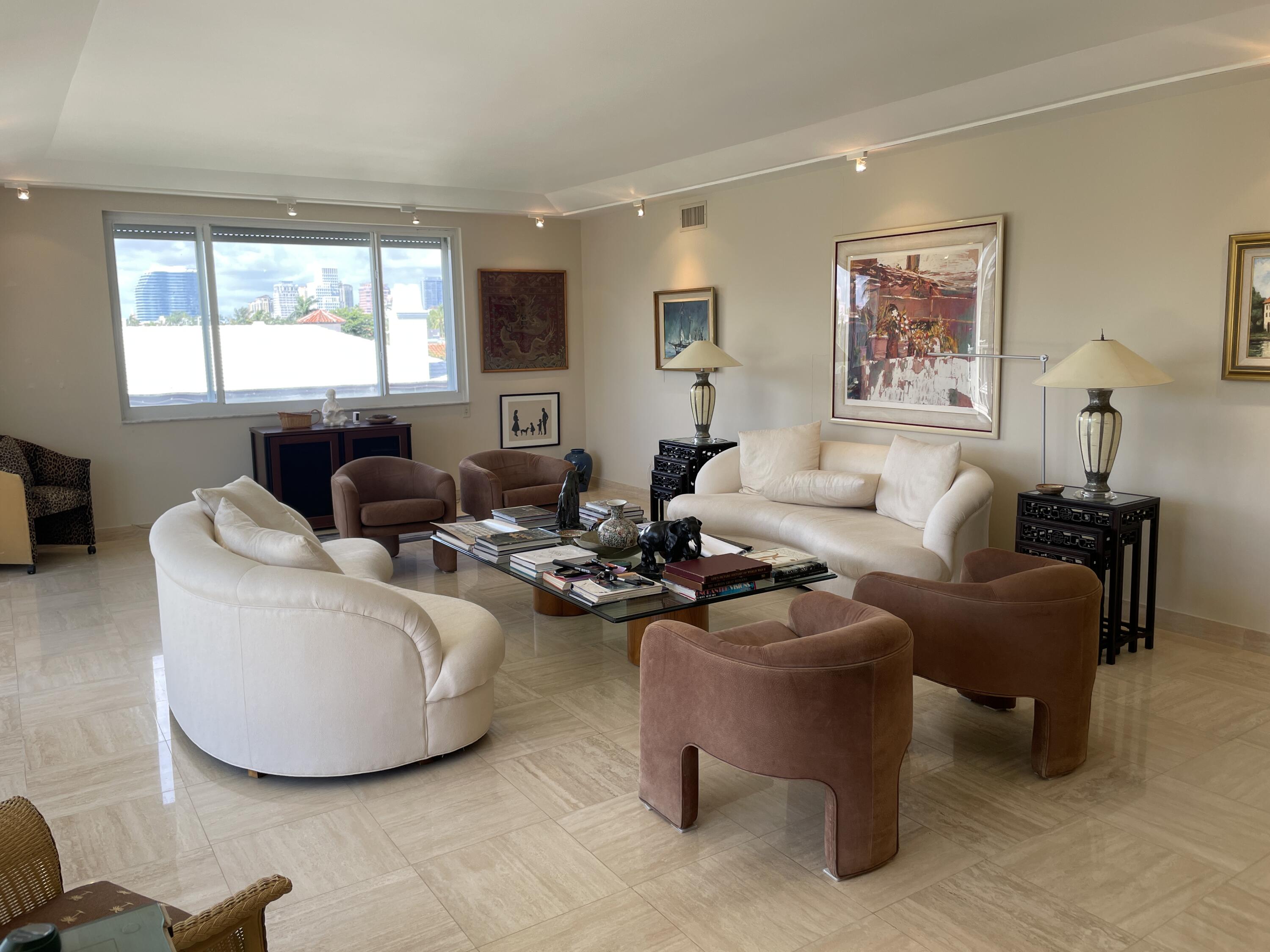 145 Peruvian Avenue, Unit 301 Palm Beach, FL 33480 - Photo 5 of 16 a living room with furniture a large window and a flat screen tv