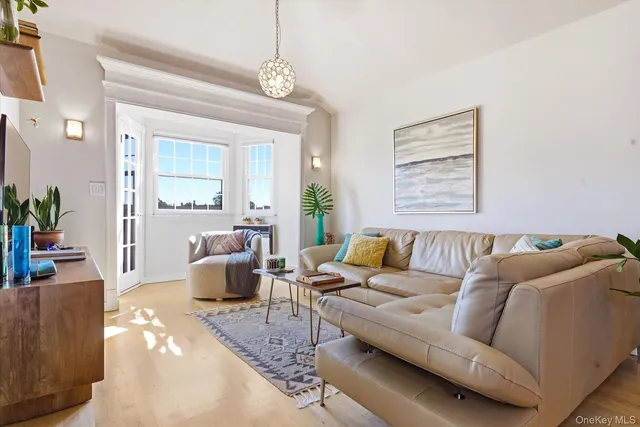 a living room with furniture and a chandelier