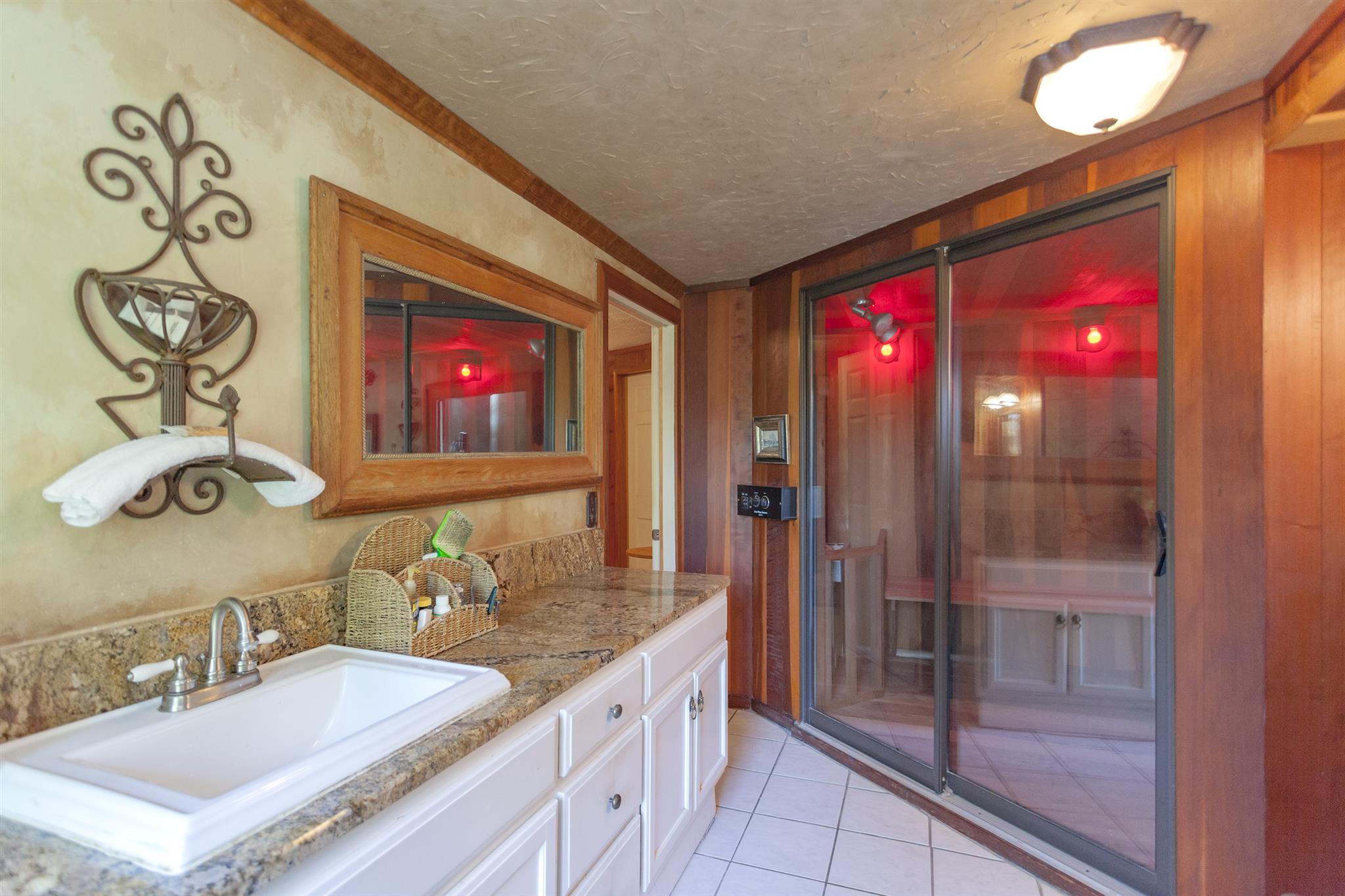 1635 Camp Ravine Road Burns, TN 37029 - Photo 19 of 28 a bathroom with a granite countertop sink a mirror and shower