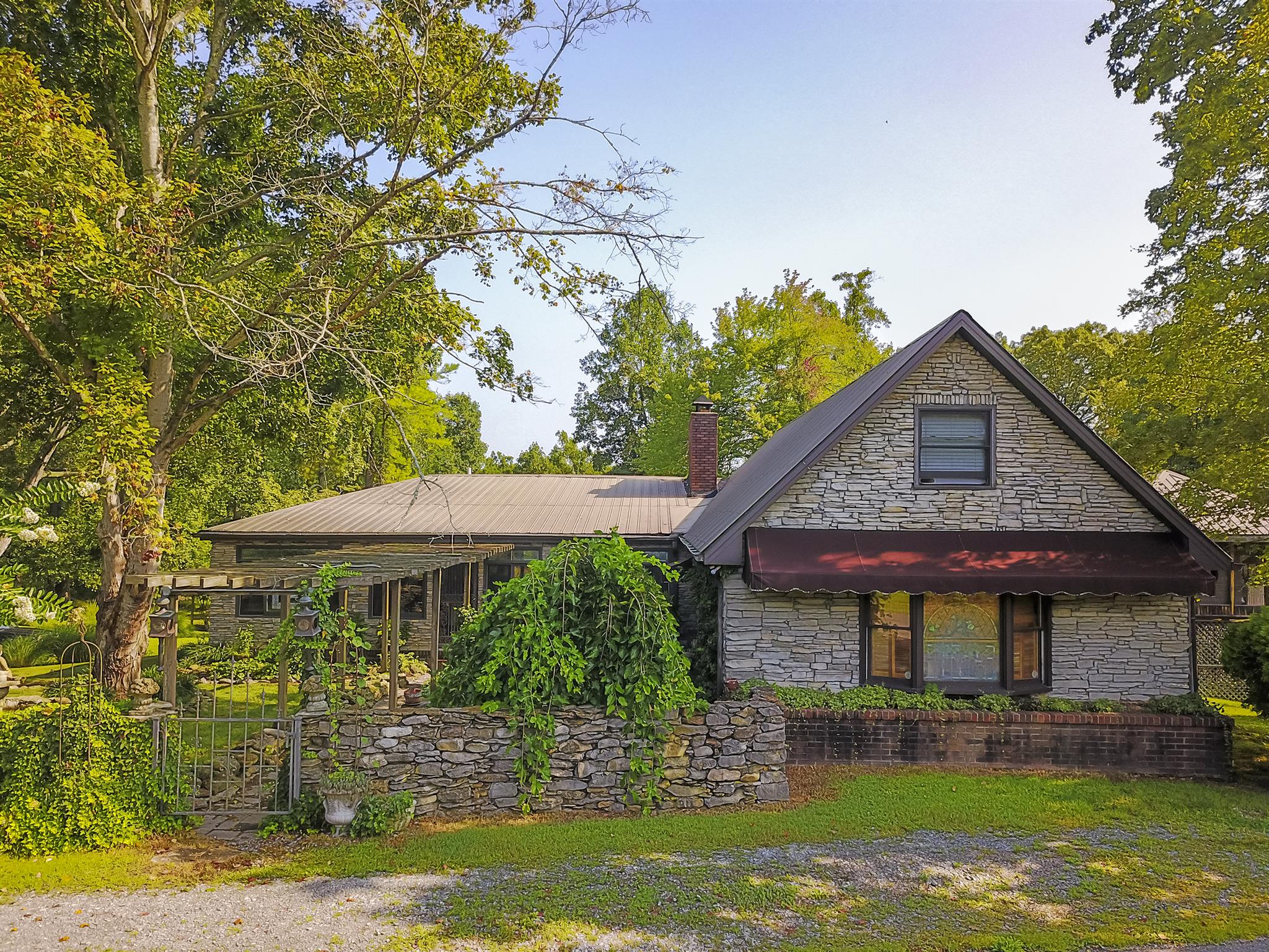 1635 Camp Ravine Road Burns, TN 37029 - Photo 2 of 28 a front view of a house with garden