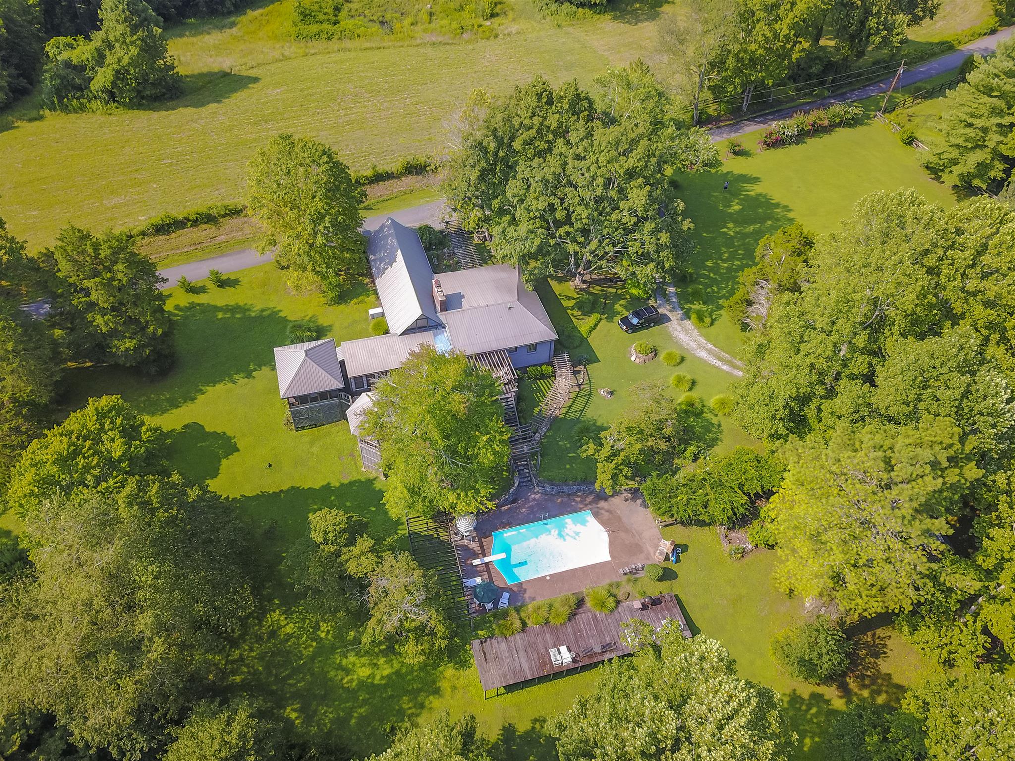 1635 Camp Ravine Road Burns, TN 37029 - Photo 5 of 28 an aerial view of a house with a garden and lake view