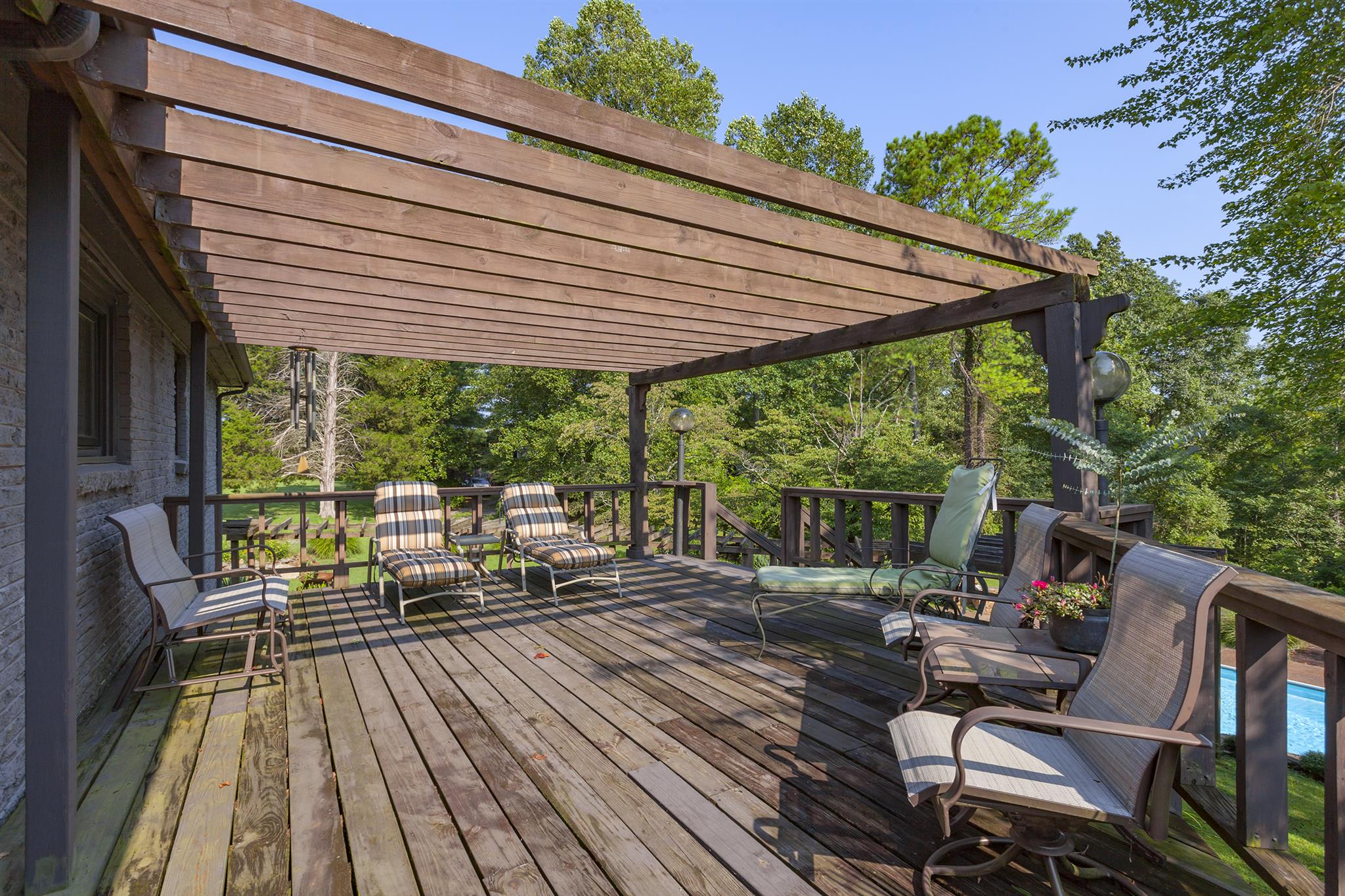 1635 Camp Ravine Road Burns, TN 37029 - Photo 9 of 28 a view of a patio with lawn chairs next to a yard