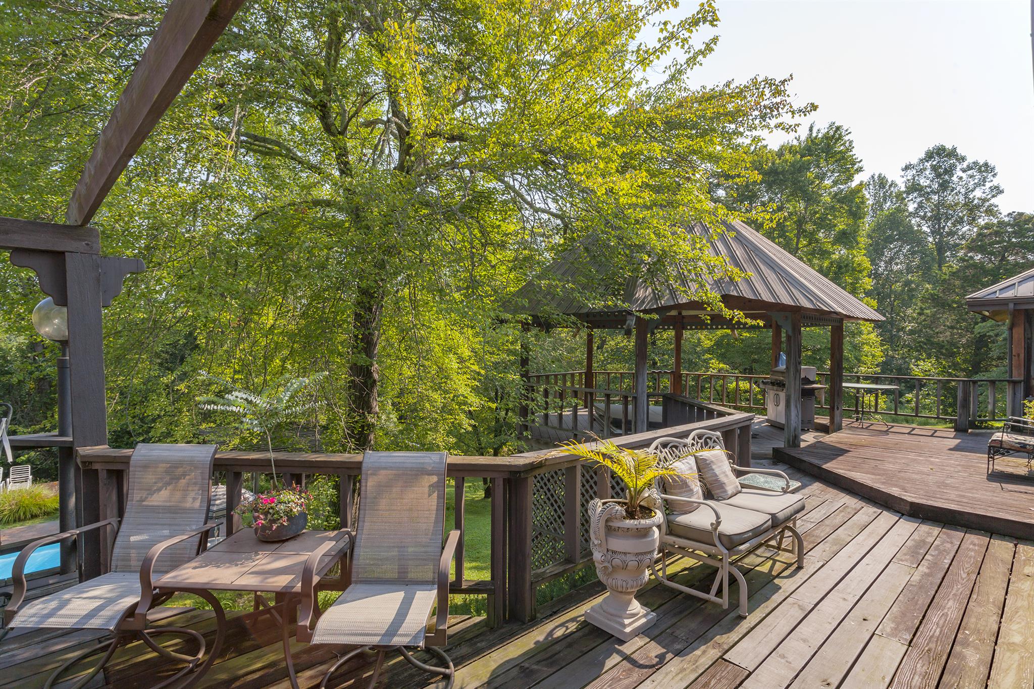 1635 Camp Ravine Road Burns, TN 37029 - Photo 10 of 28 a view of deck with furniture and trees