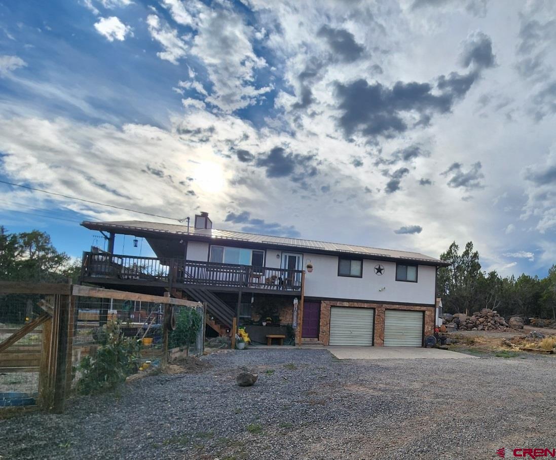 a view of a house with a backyard