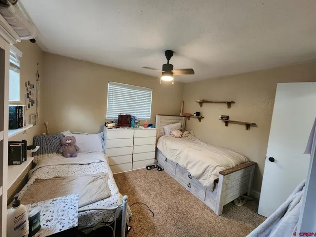 a bedroom with bed and a chandelier