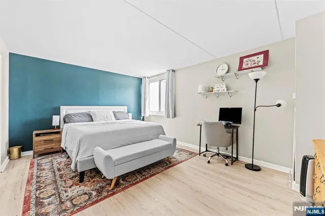 a bedroom with a bed and a table in it