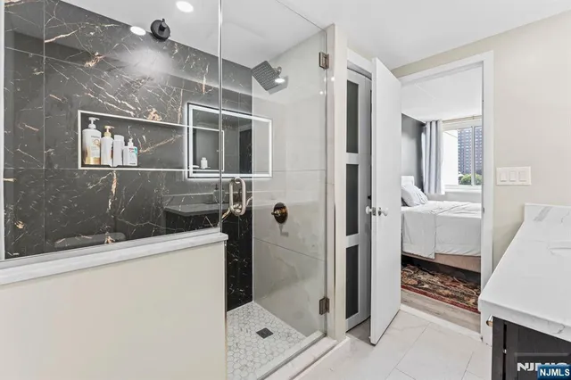 a bathroom with a shower and a sink