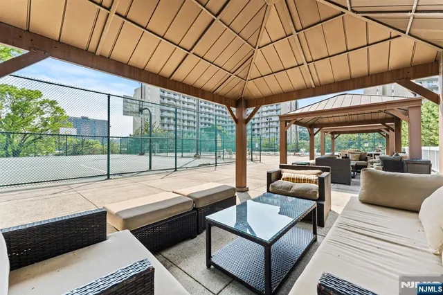 a outdoor living space with patio furniture and a grill