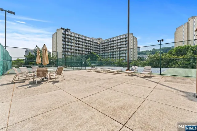 a swimming pool with outdoor seating and city view