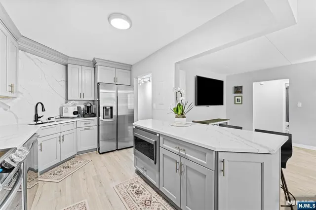 a kitchen that has a sink and a stove in it