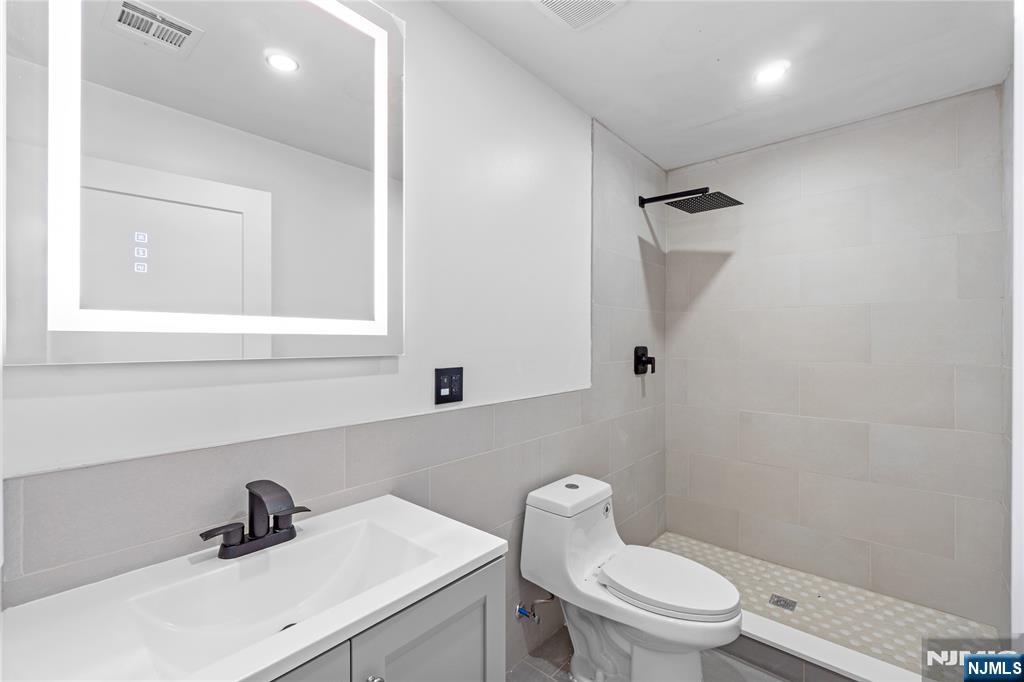 481 15th Avenue Newark, NJ 07103 - Photo 11 of 19 a bathroom with a toilet sink and mirror