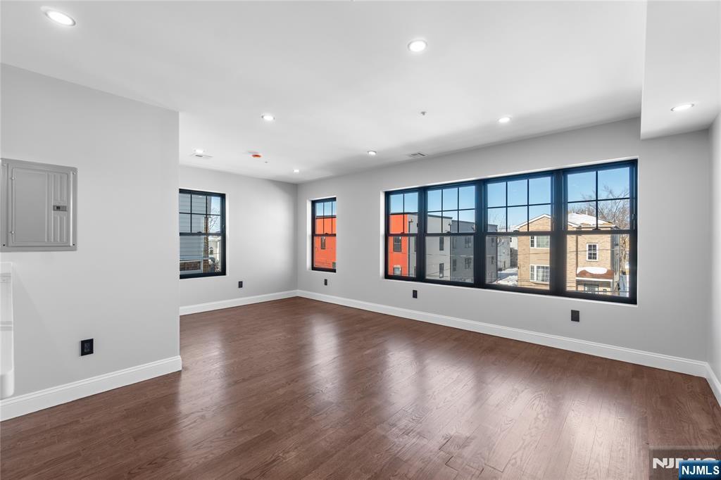 481 15th Avenue Newark, NJ 07103 - Photo 7 of 19 a view of an empty room with wooden floor and a window